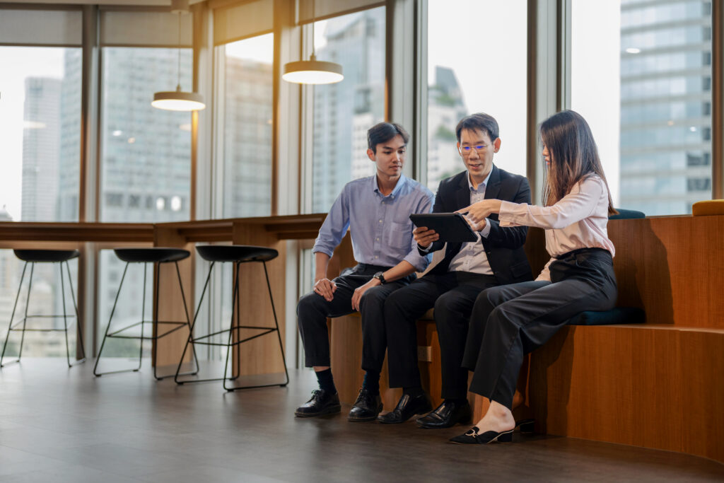 Colleagues discussing a project in an office seating area